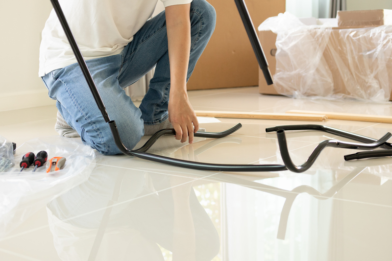 asian man assembling furniture at home